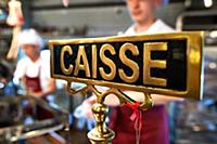 detail of vintage cash register with people at the