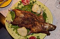 PERU / Puno / Grilled guinea pig in restaurant (Cu
