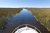 PERU / Puno / Lake Titicaca / Boat driving through