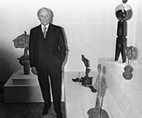 2765072 Joan Miro posing with some of his sculptur