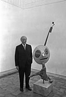 2765074 Joan Miro posing with one of his sculpture