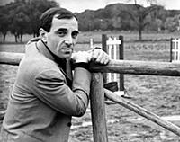 3615474 Charles Aznavour leaning against a wooden 