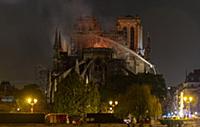 Firefighters douse flames from the burning Notre D