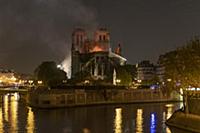 Firefighters douse flames from the burning Notre D