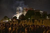 Firefighters douse flames from the burning Notre D