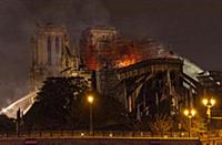 Firefighters douse flames from the burning Notre D