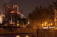 Firefighters douse flames from the burning Notre D