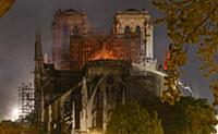 Firefighters douse flames from the burning Notre D