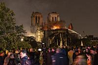 Firefighters douse flames from the burning Notre D