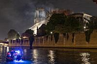 Firefighters douse flames from the burning Notre D