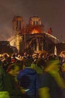 Firefighters douse flames from the burning Notre D