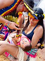 Manoky people entertain their baby on the sideline