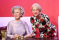 Dame Helen Mirren views three of her wax works at 