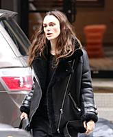 Actress Keira Knightley wears a sheepskin flying j