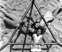 Three women having fun on the beach in the 1960s