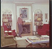Dirk Bogarde, the film star and writer, at home at