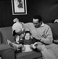 Ray Ellington, 1915-1985, at home in London with h