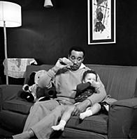 Ray Ellington, 1915-1985, at home in London with h