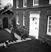 Jimmy Edwards, actor and comedian, at home. With h