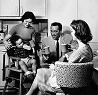 Ray Ellington, 1915-1985, at home in London with w
