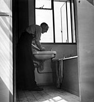 Man using  the bathroomn in one of the new prefabr