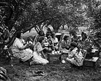 Fruit pickers at tea time during their spell of ap