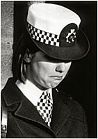 A policewoman weeps at the funeral of WPC Jane Arb