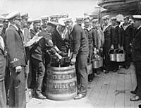 Sailors aboard HMS Hood (pennant number 51) stand 