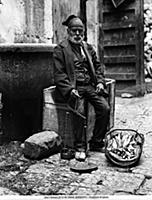 <caption>Fish vendor in traditional dress, in Girg