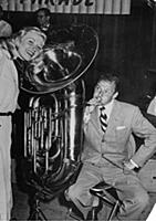 Doris Day listens as Frank Sinatra coaxes a tune o