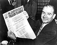 Senator Joe McCarthy grins boldly during a recess 