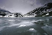 Lake covered in ice, Alps, Italy