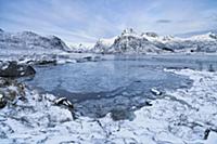 Partially frozen fjord with mountains, Lofoten Isl