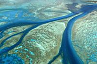 Aerial view of tidal channels in coral which feed 