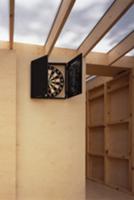 Dartboard on wooden wall of extension