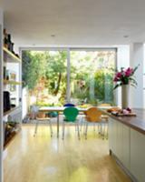 Colourful, Bauhaus shell chairs at dining table in