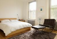 Modern bedroom with black leather Bauhaus armchair