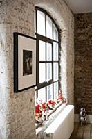 Brick interior wall and window with black metal gl