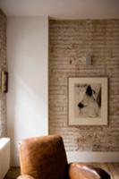 Exposed brick wall in corner of living room and pa