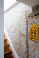 Yellow painted wall cabinet on brick wall of stair