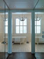 Corridor with mirrored cupboard doors and view of 