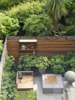 View down to fenced terrace with tiled floor, wood