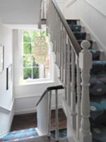 Staircase with turned balusters and patterned runn