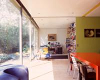 Red table in front of open, green-painted sliding 