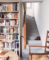 Corner of room with fitted bookcase and old, grey 