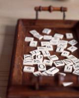 Game tiles with letters on wooden tray