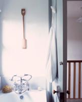 Bathtub with vintage tap fittings and open door wi