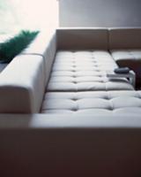 Designer couch with light upholstery and small sid