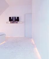 White bedroom with flokati carpet and indirect lig