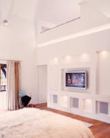 White, designer bedroom with indirect lighting in 